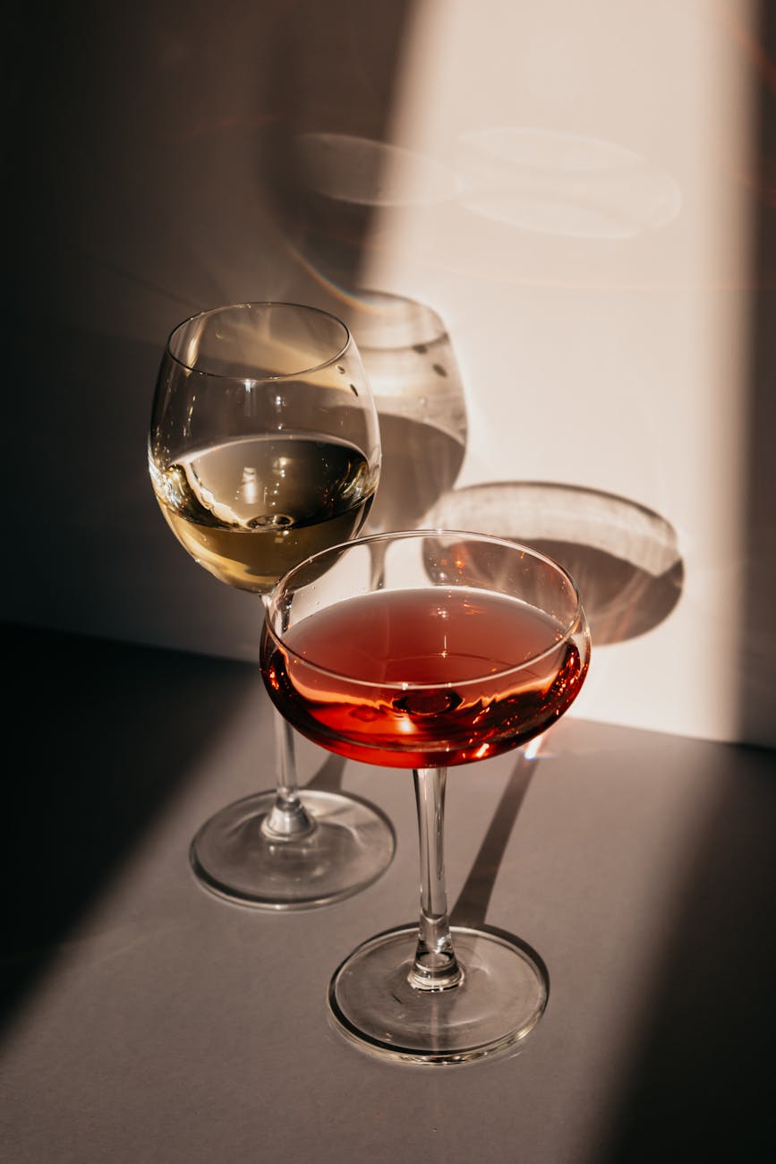 assorted alcohol drinks in elegant glasses placed on table